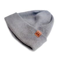 Gray SafeSleeve RF blocking beanie with a small leather logo tag, designed to protect against electromagnetic radiation.