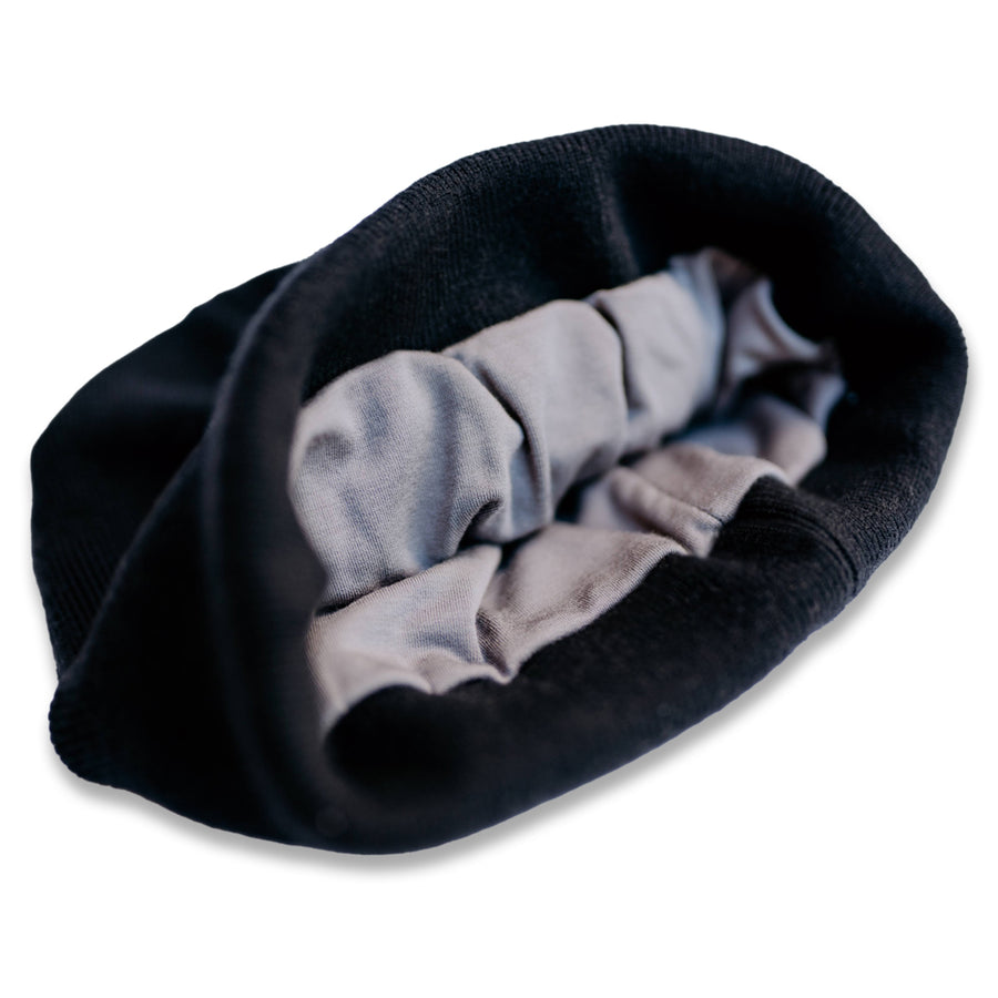 Close-up of a black beanie with RF blocking fabric, showing the interior lining designed for wireless signal protection.