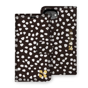 SafeSleeve detachable case for iPhone 16 series featuring a black and white spotted design with gold accents.